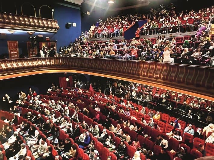 Large audience attending an event at a cinema theater in Africa, vibrant community gathering.