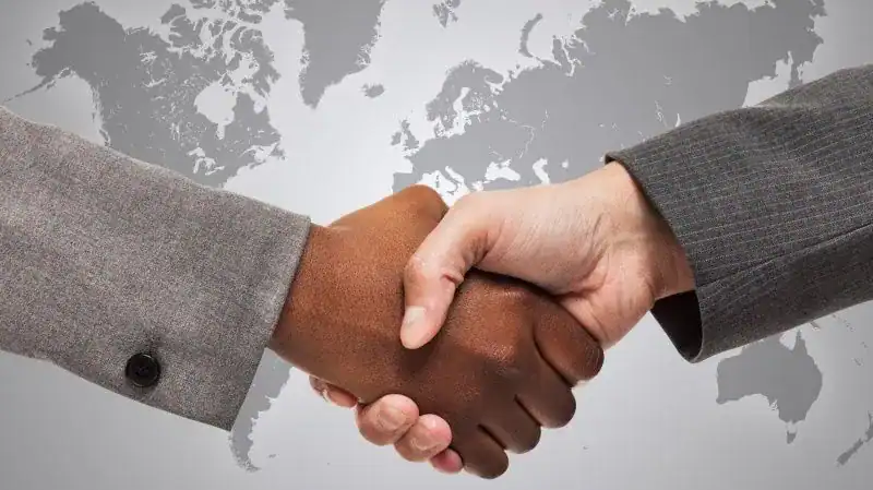 black man and white man shaking hands