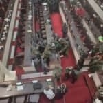 Protest near lawmakers in African legislative hall, showing civil unrest.