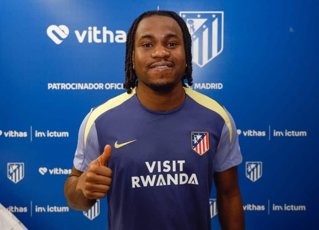 Ademola Lookman in Atlético Madrid jersey giving a thumbs-up at a press event.