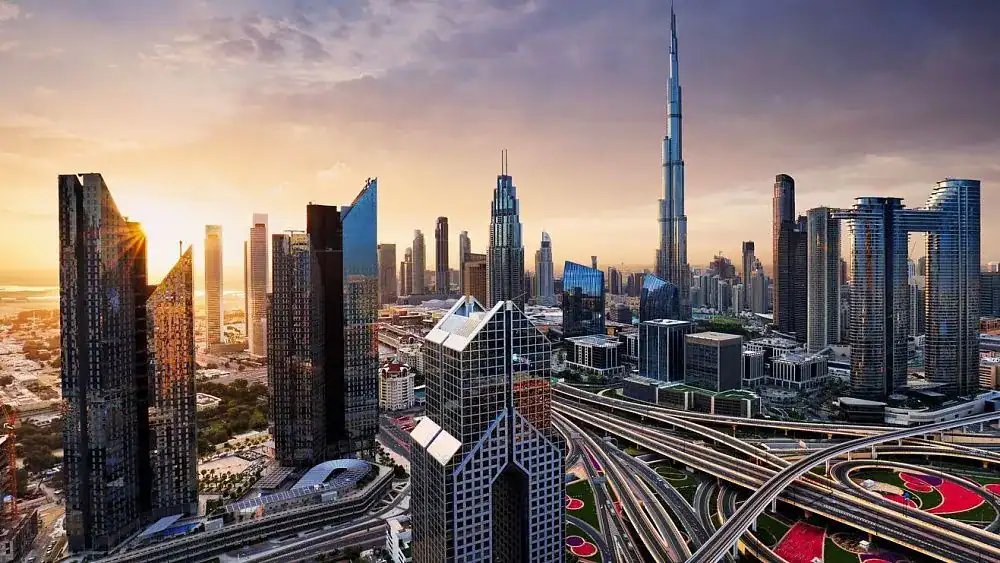 Dubai skyline with Burj Khalifa at sunset, featuring modern skyscrapers and city infrastructure.