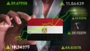 Businessperson analyzing stock market trends with Egyptian flag background.