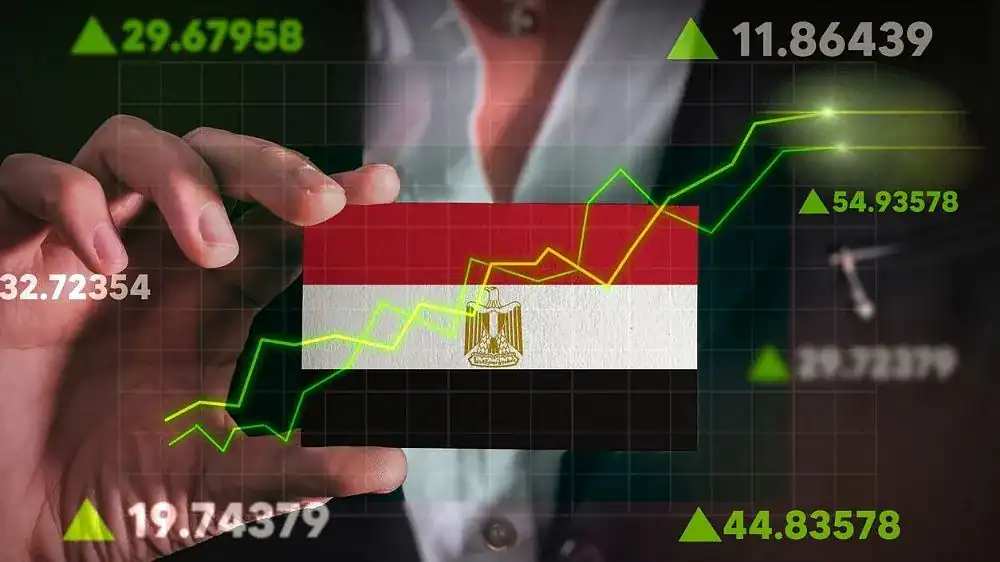 Businessperson analyzing stock market trends with Egyptian flag background.