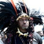 Zulu King Misuzulu ka Zwelithini wearing traditional African headdress with feathers and beads.