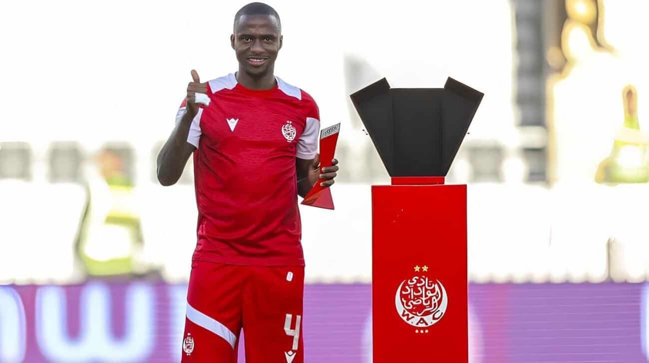 Thembinkosi Lorch celebrating football victory with trophy at wydad cassablanca soccer event.