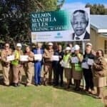 Group of people holding certificates at Nelson Mandela Rules Training Academy.