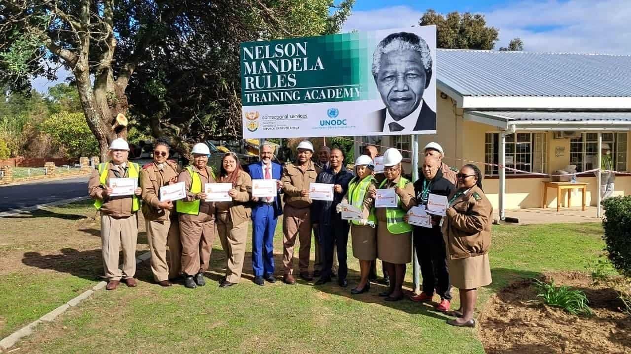 Group of people holding certificates at Nelson Mandela Rules Training Academy.