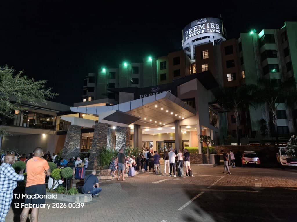 Premier Hotel Tambo Johannesburg at night with guests arriving and parking.