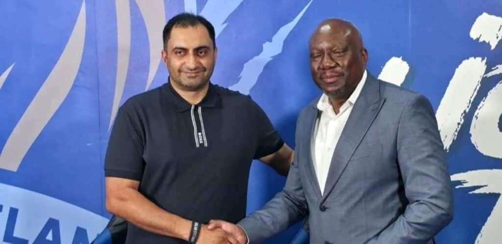 Durban City CEO Younus Kadodia and Scottland FC director Tonderai Sakupwanya shaking hands at a formal event for economic growth.
