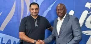 Durban City CEO Younus Kadodia and Scottland FC director Tonderai Sakupwanya shaking hands at a formal event for economic growth.