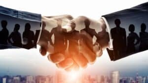 BRICS Youth ESG Dialogue shaking hands symbolizing partnership and collaboration.