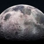 Indian Scientists Identify Subsurface Ice Near Moon’s South Pole. Moon surface with craters and rugged terrain under a starry sky.
