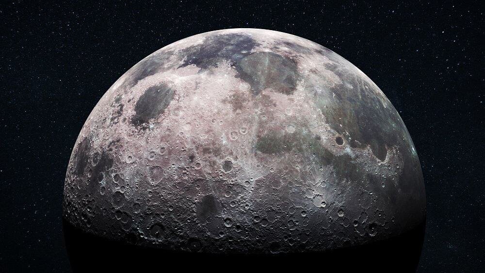 Indian Scientists Identify Subsurface Ice Near Moon’s South Pole. Moon surface with craters and rugged terrain under a starry sky.