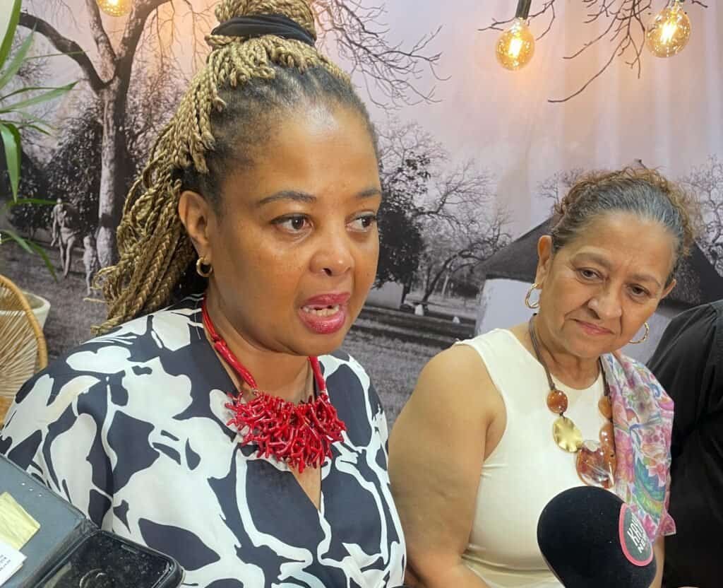 SANParks CEO Hapiloe Sello (with red) and SANParks Interim Board Chairperson Beryl Ferguson speaking with the media at the SANParks stand during the Africa’s Travel Indaba 2026 in Durban