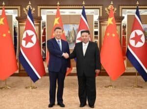 Xi Jinping, general secretary of the Communist Party of China Central Committee and Chinese president, shakes hands with Kim Jong Un, general secretary of the Workers' Party of Korea (WPK) and president of the State Affairs of the Democratic People's Republic of Korea (DPRK) in Pyongyang.