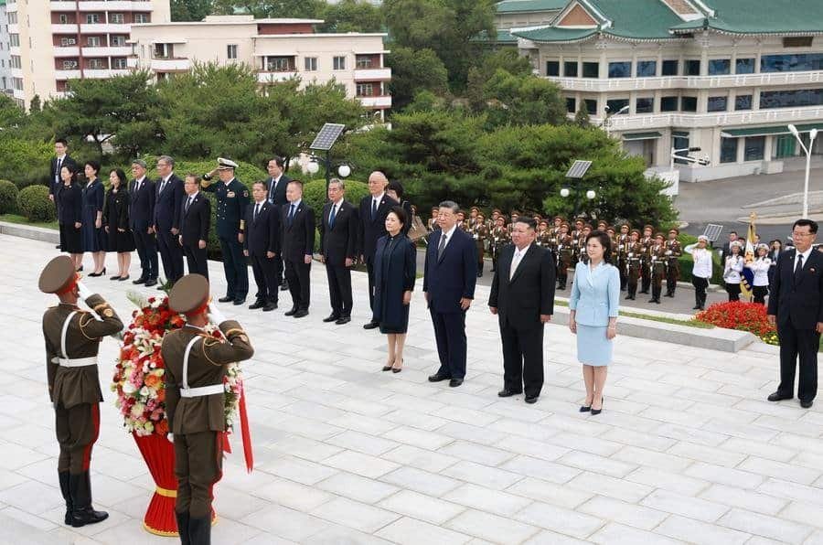 Xi Jinping, general secretary of the Communist Party of China Central Committee and Chinese president, pays homage to the China-DPRK Friendship Tower with his wife Peng Liyuan, in the company of Kim Jong Un, general secretary of the Workers' Party of Korea and president of the State Affairs of the Democratic People's Republic of Korea (DPRK), and Kim's wife Ri Sol Ju, in Pyongyang, the DPRK