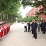 Chinese President Xi Jinping talks with students and teachers in a square of Beijing Yuying School