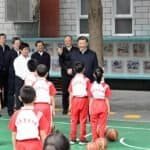 Chinese President Xi Jinping, also general secretary of the Communist Party of China Central Committee and chairman of the Central Military Commission, talks with students on the basketball court of Beijing Yuying School in Beijing