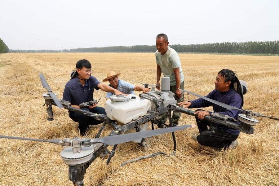 Han Xuerun (1st L) instructs villagers to use a plant protection drone in Hubin Town of Boxing County, Binzhou, east China's Shandong Province, June 15, 2026. (Photo by Chen Bin/Xinhua)