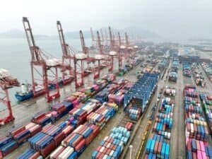 An aerial drone photo taken on July 14, 2026 shows cargo ships loading and unloading containers at a container terminal of Lianyungang Port, east China's Jiangsu Province. (Photo by Wang Chun/Xinhua)