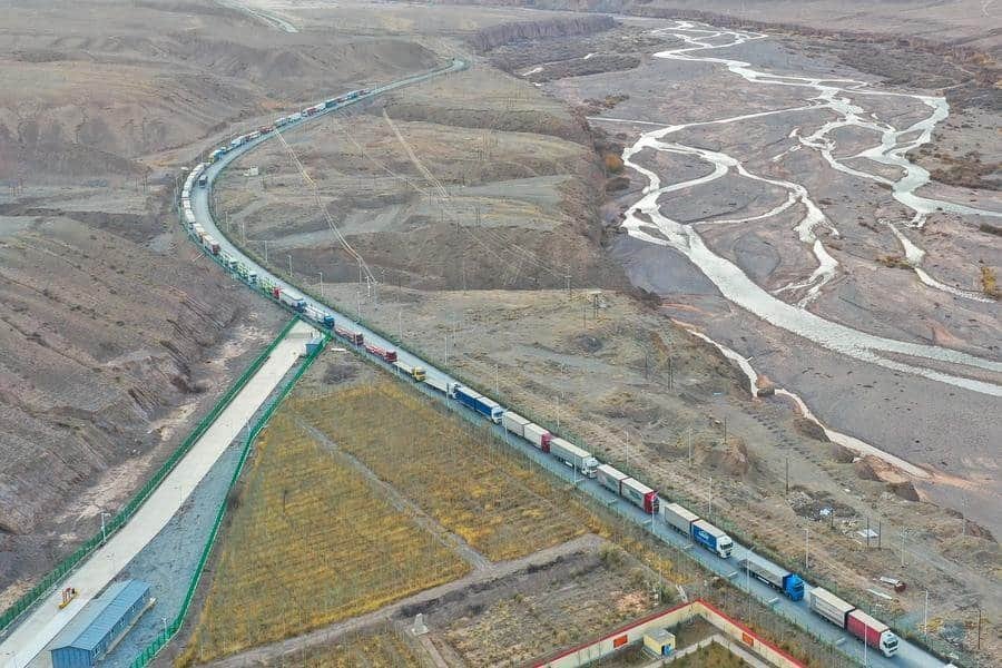 This aerial photo taken on Nov. 7, 2023 shows trucks entering the Irkeshtam port in northwest China's Xinjiang Uygur Autonomous Region. (Xinhua/Ding Lei)
