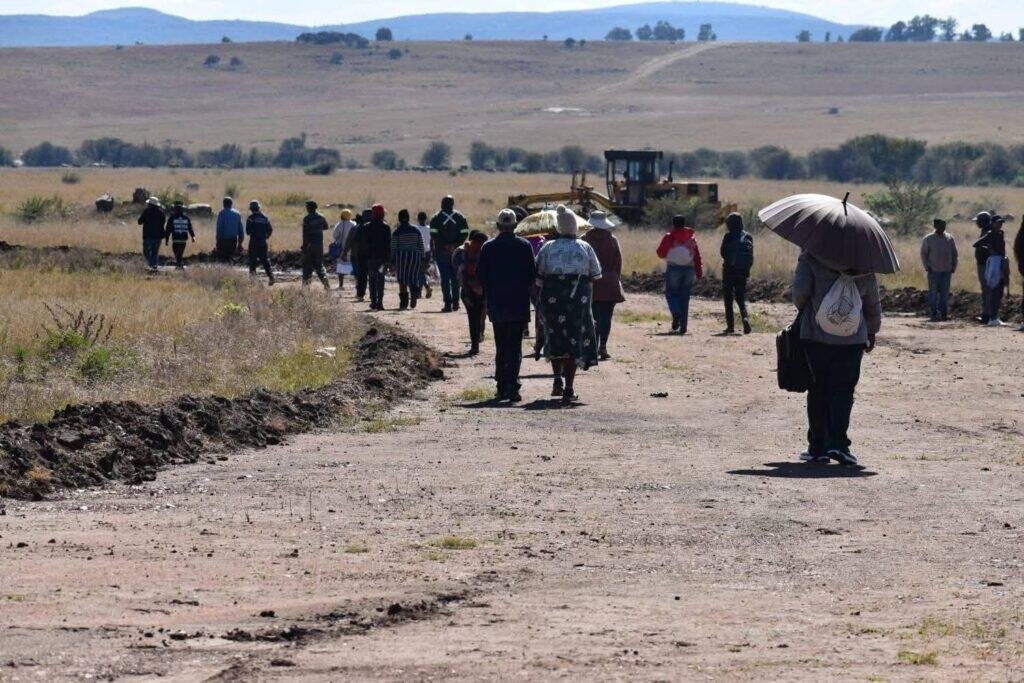 People walking along a road at the Ngwathe Local Municipality in the Free State province of South Africa.