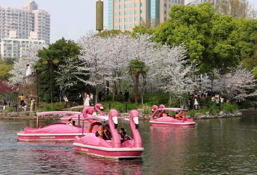People take boats at a park during the Qingming Festival holiday in east China's Shanghai, April 4, 2026.