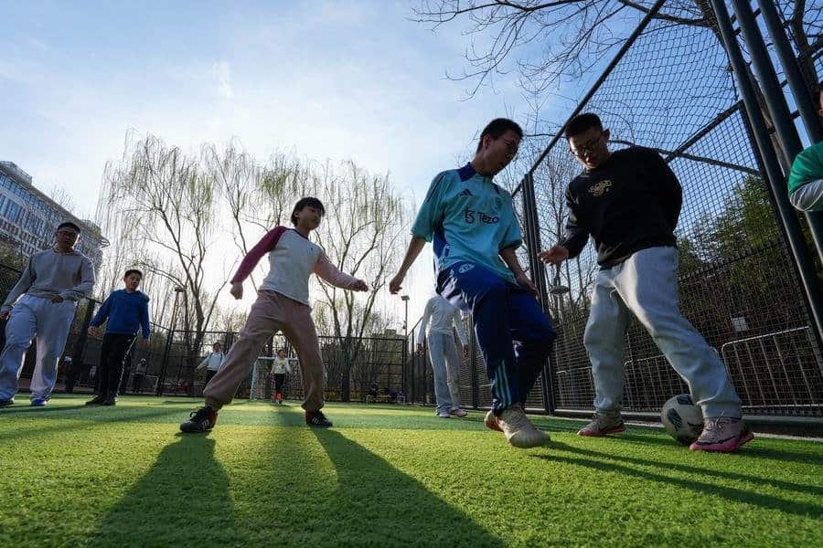 People play football in an urban park for free in Beijing, capital of China, March 22, 2026. (Xinhua/Xie Han)