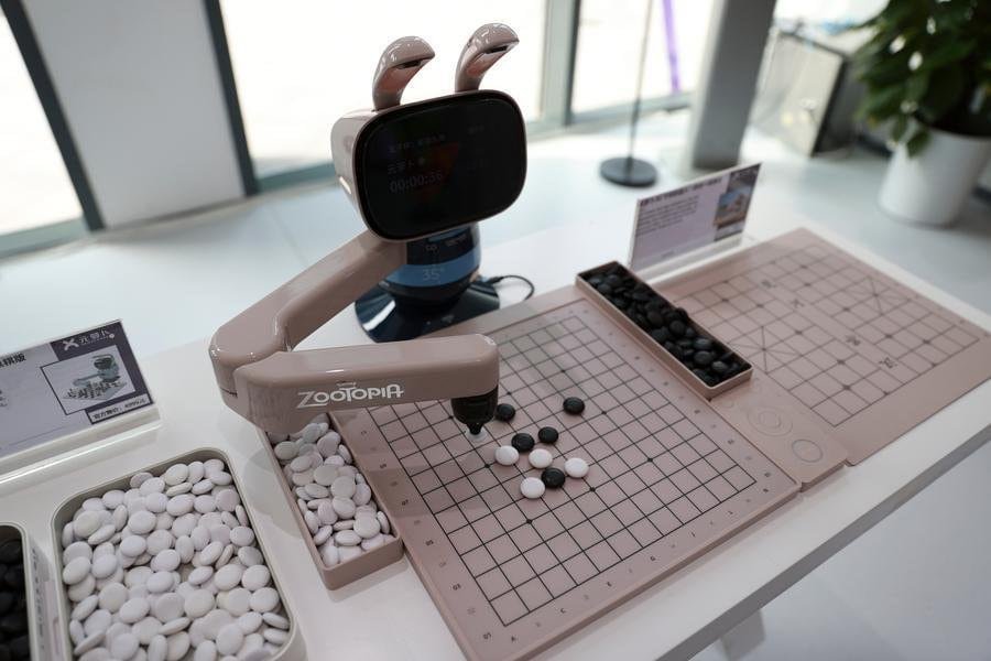 An AI-powered chess robot of SenseRobot plays a board game with a visitor in Beijing E-Town of Beijing, capital of China, July 1, 2026. (Photo by Ma Zihan/Xinhua)