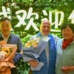 Ronald Sakolsky (C), Yin Yuzhen (R) and Yin's husband Bai Wanxiang pose for photos at an airport in Ordos, north China's Inner Mongolia Autonomous Region, Aug. 23, 2026. (Xinhua/Lian Zhen)
