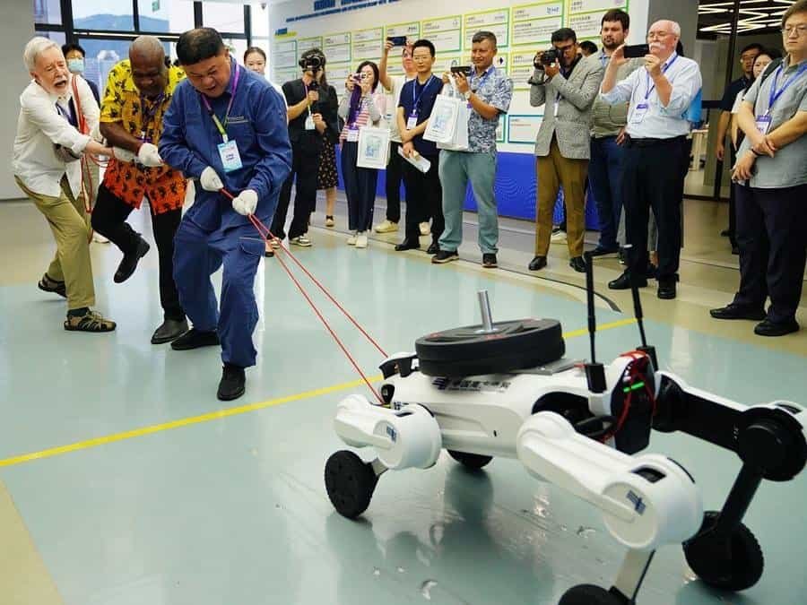 Guests have a tug-of-war competition with an intelligent inspection robot dog at Hengqin Digital Zero-Carbon Island Shared Laboratory of China Southern Power Grid (CSG) in Zhuhai, south China's Guangdong Province, Sept. 3, 2026. (Xinhua/Li An)