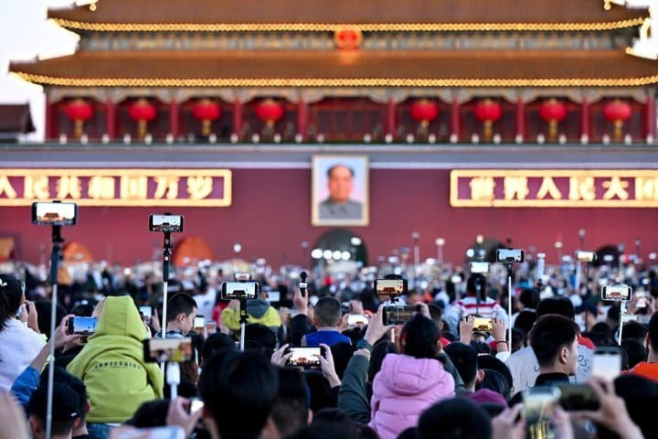 People attend a flag-raising ceremony marking the 77th anniversary of the founding of the People's Republic of China at Tian'anmen Square in Beijing, the capital of China, Oct. 1, 2026. (Photo by Lin Jinhai/Xinhua)