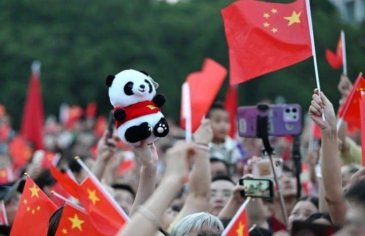 People attend a flag-raising ceremony marking the 77th anniversary of the founding of the People's Republic of China at Wuyi Square in Fuzhou, southeast China's Fujian Province, Oct. 1, 2026. People celebrated the 77th anniversary of the founding of the People's Republic of China in various ways on Thursday. (Photo by Lin Shanchuan/Xinhua)
