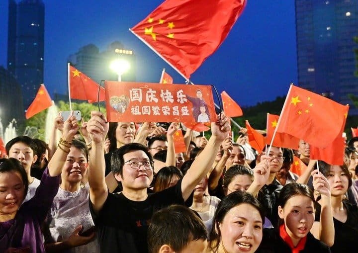 People attend a flag-raising ceremony marking the 77th anniversary of the founding of the People's Republic of China at Wuyi Square in Fuzhou, southeast China's Fujian Province, Oct. 1, 2026. People celebrated the 77th anniversary of the founding of the People's Republic of China in various ways on Thursday. (Photo by Lin Shanchuan/Xinhua)