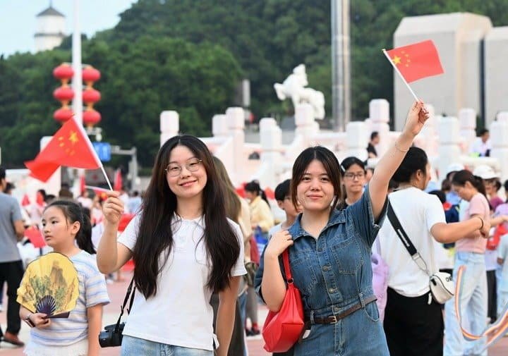 People attend a flag-raising ceremony marking the 77th anniversary of the founding of the People's Republic of China at Wuyi Square in Fuzhou, southeast China's Fujian Province, Oct. 1, 2026. People celebrated the 77th anniversary of the founding of the People's Republic of China in various ways on Thursday. (Photo by Lin Shanchuan/Xinhua)