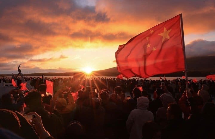 People watch the sun rise in Fuyuan City, northeast China's Heilongjiang Province, Oct. 1, 2026. People celebrated the 77th anniversary of the founding of the People's Republic of China in various ways on Thursday. (Photo by Li Yonguin/xinhua)
